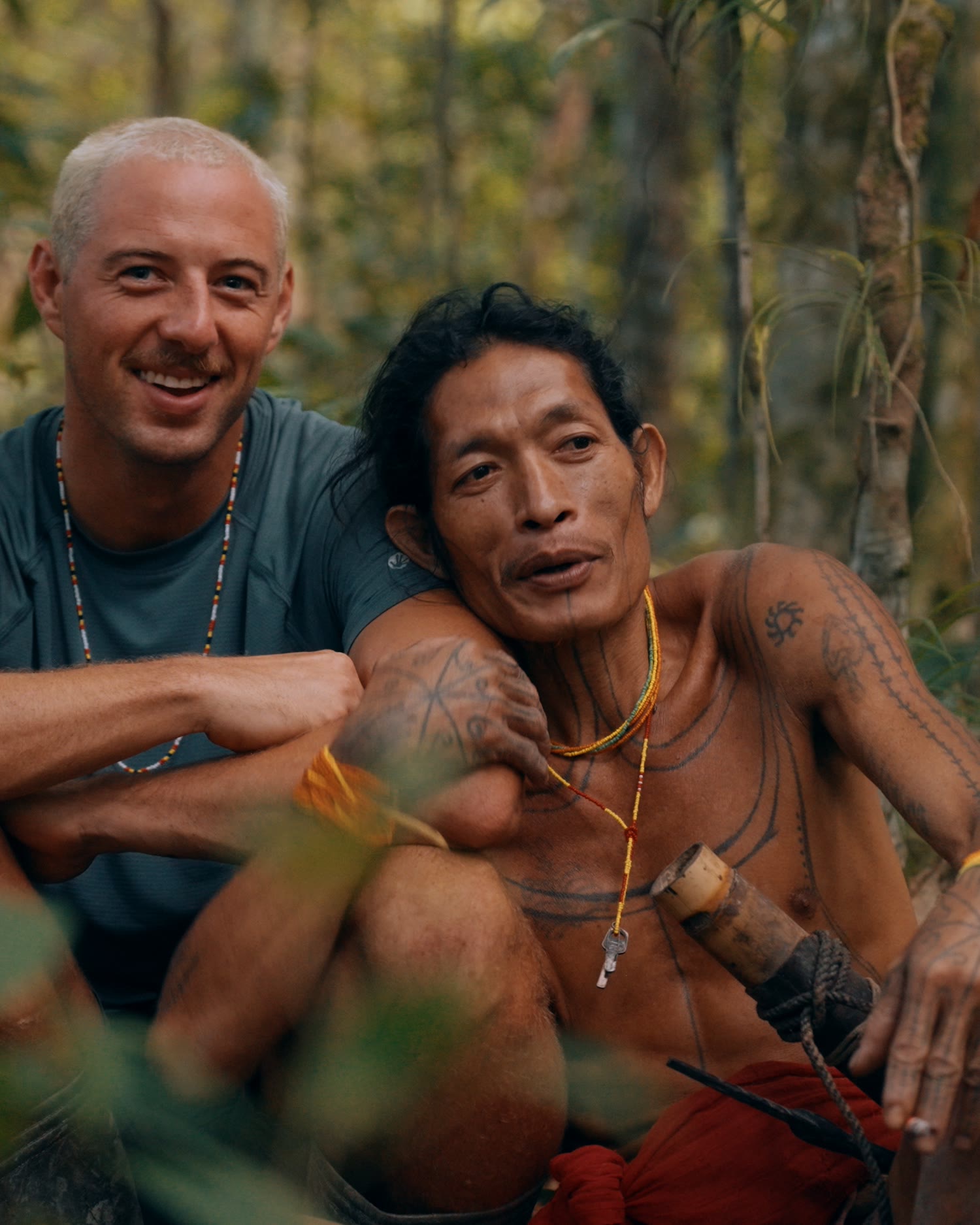 Blair sitting with members of the Mentawai tribe