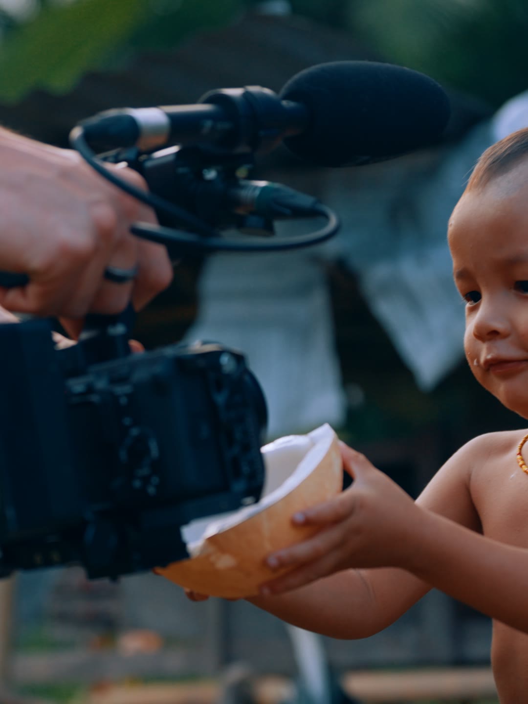 Blair filming a Mentawai child