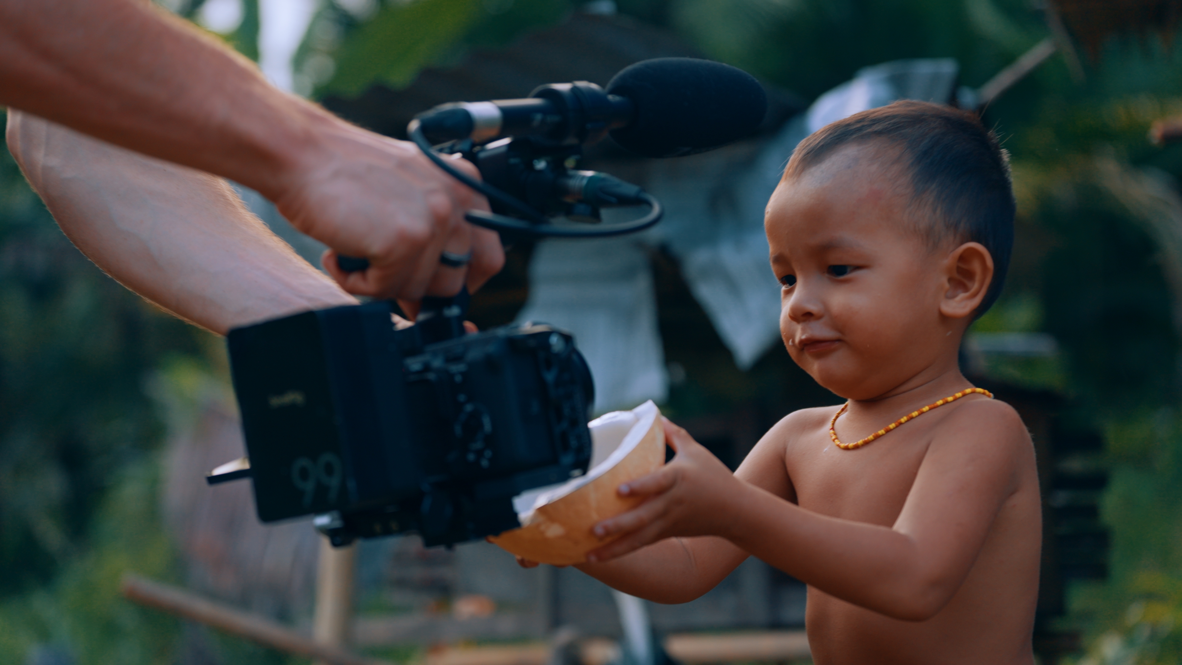 Blair filming a Mentawai child