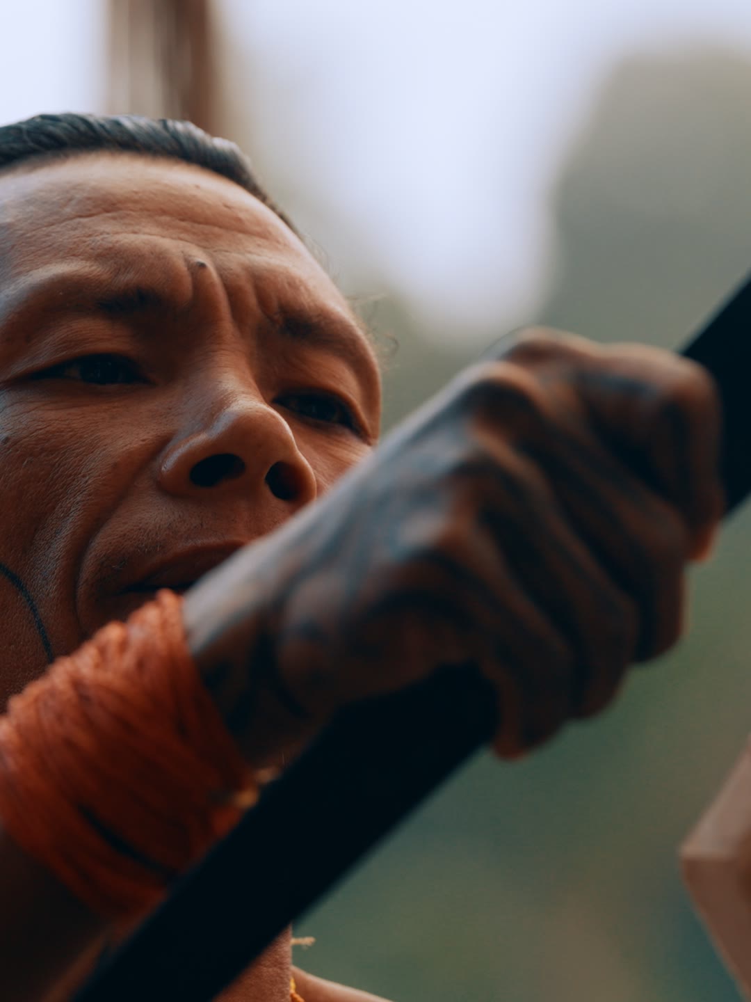 Amanako carving a bird