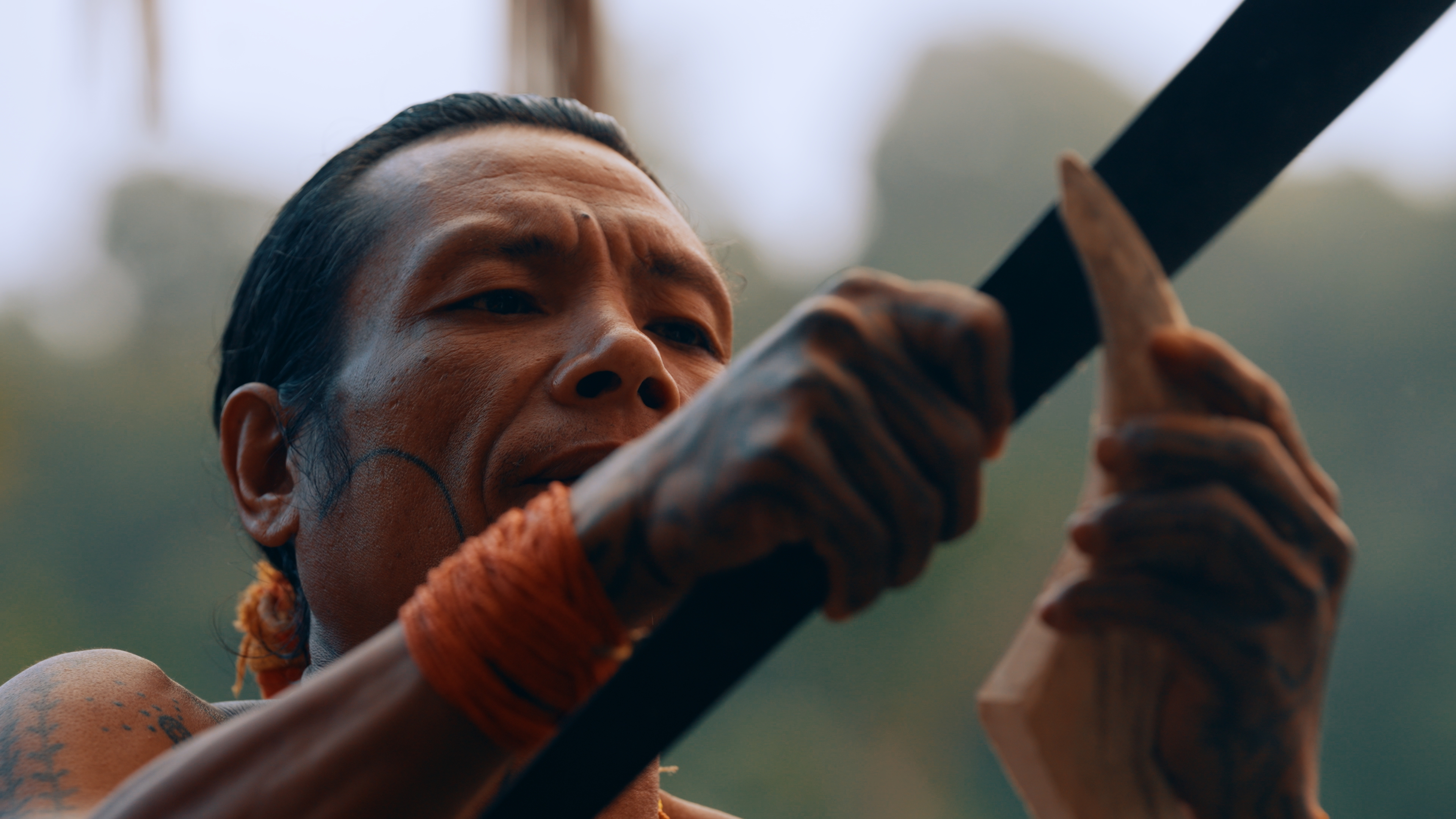 Amanako carving a bird