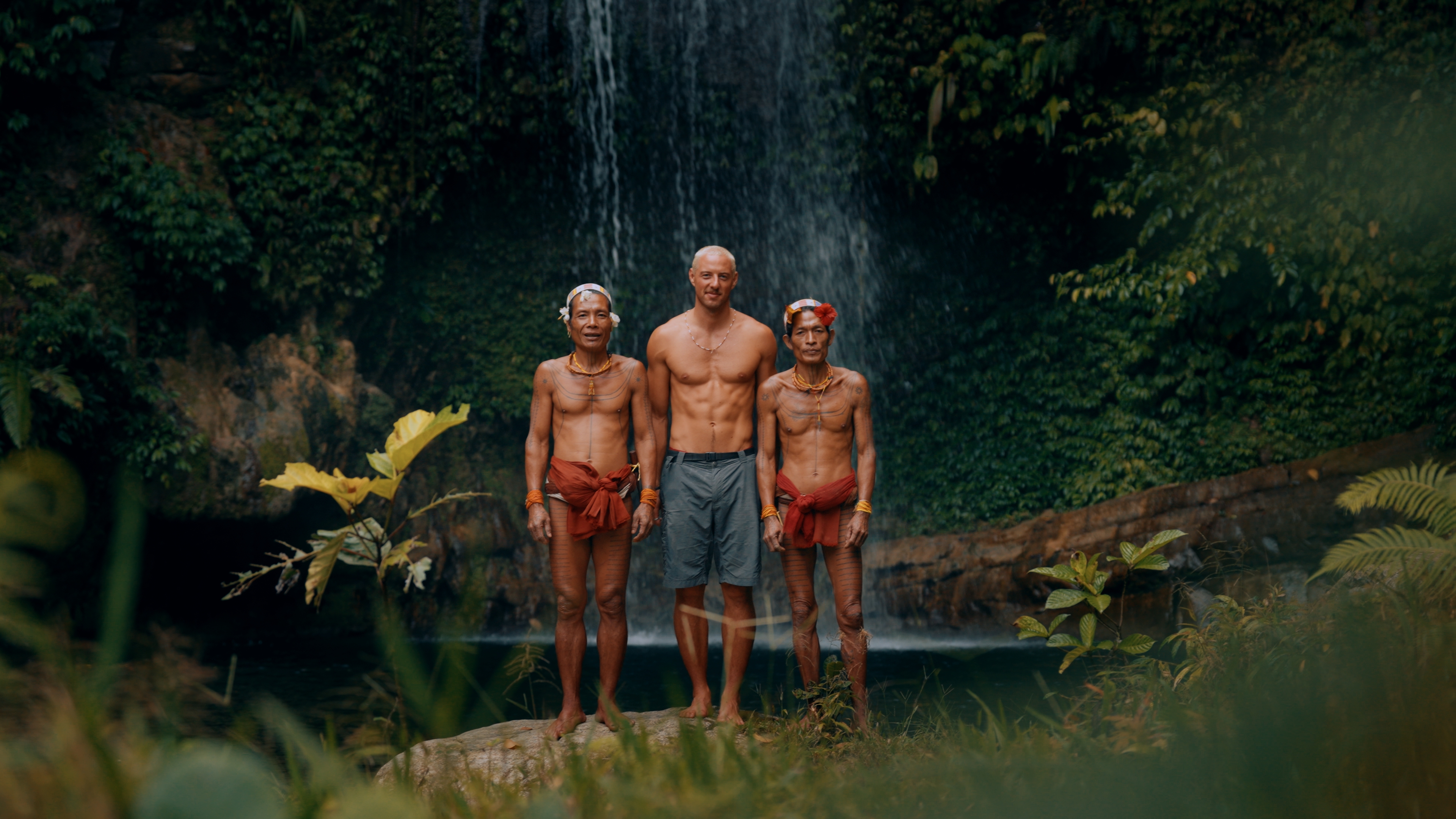 Blair and Mentawai tribe members at a waterfall